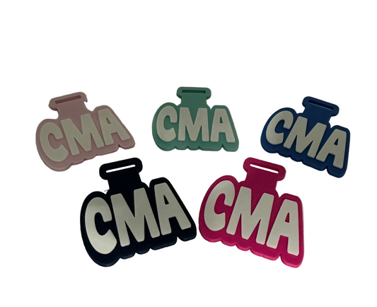 Five 'CMA' shaped cutouts in different colors on a white background